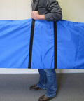 Side view of Road Ready Carry Case For Five Half Foot Drum Shield Screen Cage, blue fabric and padded straps being held.