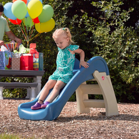 Child playing on blue Play And Fold Junior Slide For Toddlers 1.5 To 4 Years Old Indoor Outdoor Backyard Playground Set.