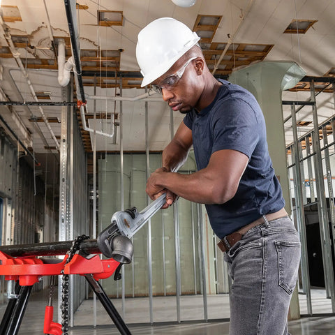 Worker using Ultra Lightweight Aluminum 18 Inch Pipe Wrench With I Beam Handle for quick adjustments on construction site.