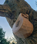 Nordic Style Kuksa Wood Camp Mug 10 Oz Handcrafted Carved Hardwood Outdoor Cup for Camping Adventure attached to a tree