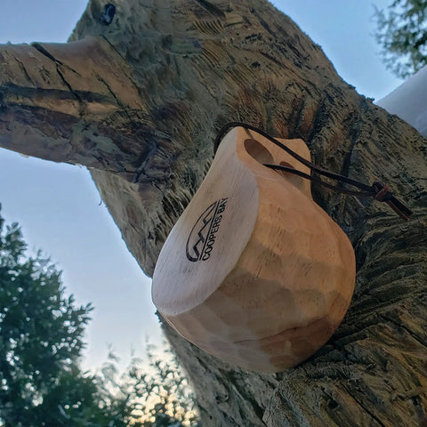 Nordic Style Kuksa Wood Camp Mug 10 Oz Handcrafted Carved Hardwood Outdoor Cup for Camping Adventure attached to a tree