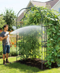 Big Ol 7.22 Foot Tall Double Arch Garden Trellis For Climbing Plants And Flowers with vines, man watering with hose