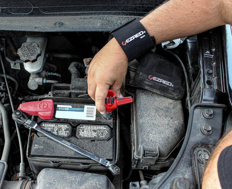 Person using 5 Piece Battery Maintenance Kit With Terminal Cleaner, 10mm Ratchet, Battery Pliers on car battery