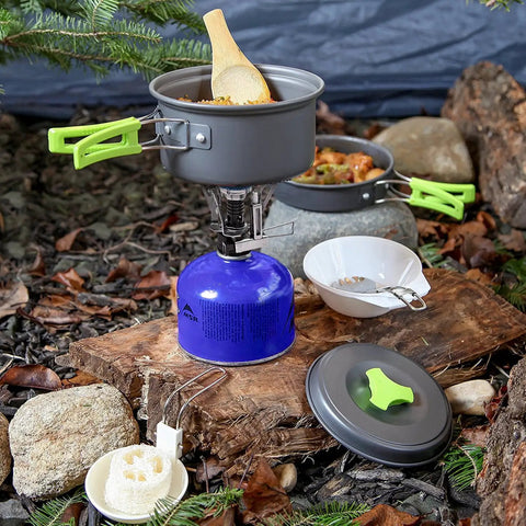 Backpacking Cooking Kit 10 Piece Non Toxic Anodized Aluminum Camp Cookware Set with stove and pots in outdoor setting
