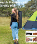 Woman carrying Free Standing Outdoor Hammock With Heavy Duty Stand Navy Blue For Backyard Patio And Garden Lounging bag next to a tent