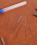 Ten Piece Stainless Steel 3D Printer Nozzle Cleaning Kit With Precision Needles From 0.15 To 1.0mm placed on a leather surface