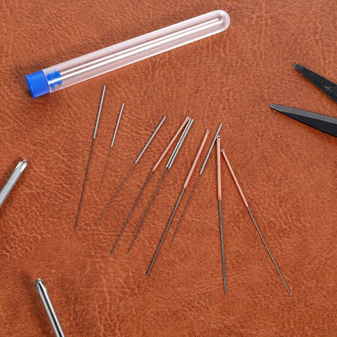 Ten Piece Stainless Steel 3D Printer Nozzle Cleaning Kit With Precision Needles From 0.15 To 1.0mm placed on a leather surface