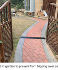Small Floor Cord Cover And Cable Protector Drop Over Ramp One Channel PVC Black on brick garden path through gate