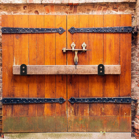 2x4 Door Barricade Brackets Heavy Duty U Shaped Security Holders on wooden garage doors, installed for protection and security