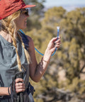 Person holding Hydration Tube Replacement Kit For Hoser System With Self Sealing HyFLO Bite Valve in outdoor setting
