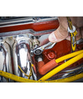 Close-up of 25 Piece Combination Ratcheting Wrench Set with Off Corner Loading being used in tight engine space.