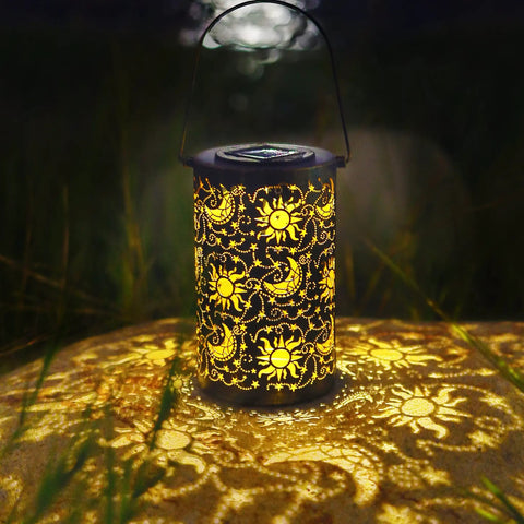 Outdoor Solar Lanterns For Garden Decor, Hanging Metal Sun Moon Star Lights glowing in a garden setting at night
