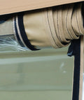 Detail of rolled-up QuadGear Extreme UTV Cab Enclosure For Polaris Ranger XP HD In Realtree Hardwoods, showing straps and clear window material.