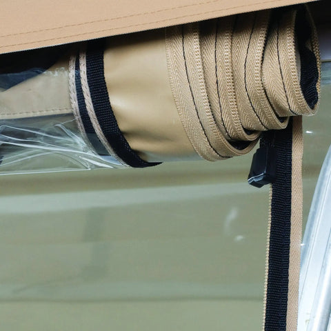 Detail of rolled-up QuadGear Extreme UTV Cab Enclosure For Polaris Ranger XP HD In Realtree Hardwoods, showing straps and clear window material.