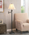 Wentworth Swing Arm Floor Lamp In Burnished Bronze Finish Your Go To Reading Light With 22 Inch Extension Arm And Cream Shade For Living Room Or Office next to an armchair