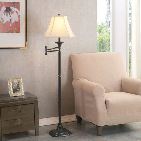 Wentworth Swing Arm Floor Lamp In Burnished Bronze Finish Your Go To Reading Light With 22 Inch Extension Arm And Cream Shade For Living Room Or Office next to an armchair