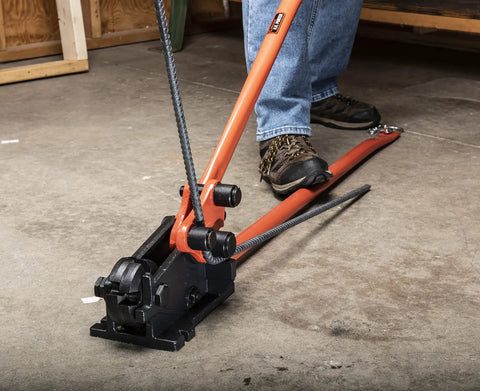 Workhorse Rebar Cutter And Bender For 5/8 Inch Steel in use, mounted on flat surface, cutting rebar with shear cut blades.