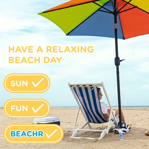 Person relaxing under a multi-color umbrella with Universal Beach Umbrella Anchor Spike For Sand, Windproof Up To 50 MPH, Rust Resistant.