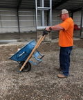Man using Pivoting Wheelbarrow Handles Pro Grade Heavy Duty Ergonomic Nylon Grips Built In USA For Easy Dumping And Total Control