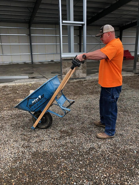 Man using Pivoting Wheelbarrow Handles Pro Grade Heavy Duty Ergonomic Nylon Grips Built In USA For Easy Dumping And Total Control