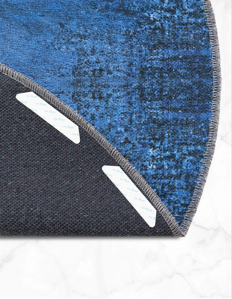 Corner of a blue rug lifted showing 12 Pack Rug Tape No Slip Rug Pad Reusable Washable Grippers For Rugs Double Sided Anti Slip Rug Stoppers