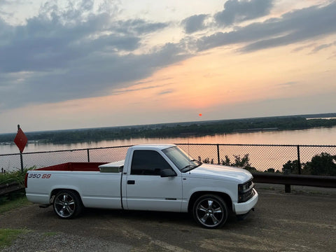White Chevy Silverado 1500 1988 To 1998 Lowering Kit With 5 Inch Front Drop Spindles parked by a lake at sunset