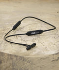 Workday Ready Earplug Earbuds With 27 dB Noise Reduction, OSHA Compliant Bluetooth Hearing Protection, on wood surface