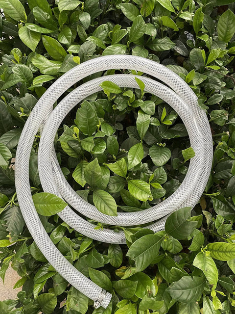 Three Quarter Inch ID By One Inch OD High Pressure Braided Clear PVC Tubing Ten Foot Heavy Duty Flexible Vinyl Hose coiled on leaves.