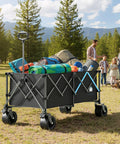 Heavy Duty 48 Inch XL Collapsible Wagon Cart with all terrain wheels and 560 lb capacity carrying camping gear on grass