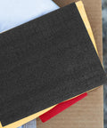 Black Foam Storage Box With Sponge Padding for Electronics and Household Items atop other packaging materials