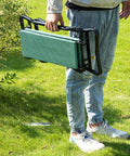 Person holding a folded Padded Garden Kneeler And Seat Bench With Extra Thick Foam, Foldable Steel Frame, Lightweight And Portable.