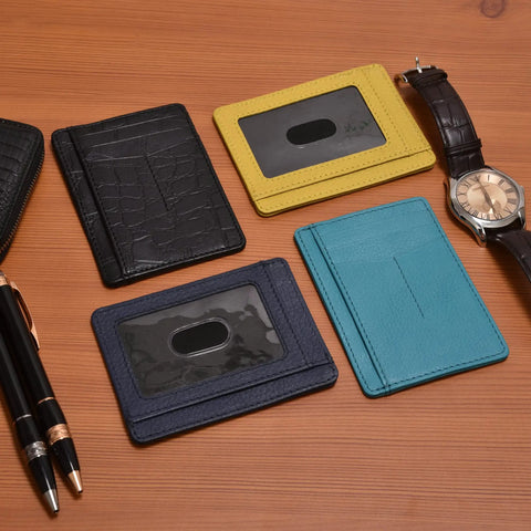 Leather Slim Minimalist Wallet With RFID Protection For Men And Women Front Pocket Card Holder In Ebony on wooden surface