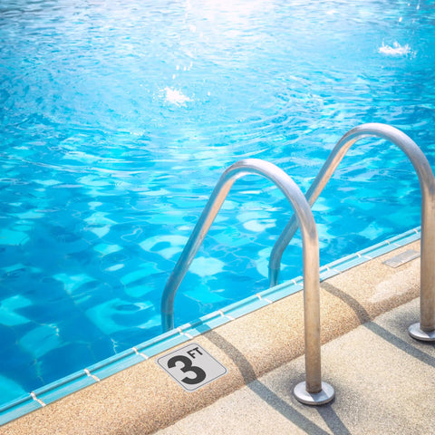 Outdoor pool with metal ladder and 3-foot depth marker, featuring 5Ft Pool Depth Stickers 2 Pack Anti Slip Vinyl Markers 6x6 Inches Waterproof No Diving Safety Signage For Pool Decks Outdoor Durable Skid Resistant Poolside Markers.