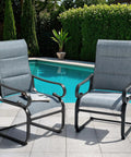 Set Of Two Padded Textilene Patio Dining Chairs With C Spring Rocker Action And Curved Armrests Rock Solid Powder Coated Metal Frame near pool.