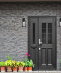 Capulet Amber Glass Center Column Outdoor Indoor Wall Sconce With LED Black Finish by a black entrance door