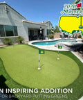Backyard putting green with 8x6 Inch Double Sided Silk Printed Golf Flag For Putting Green Practice Indoors Or Outdoors Pro Grade Game Ready Durable 420D Nylon Majors 2026 Tradition Design 1 Pack Green displayed, sunny day, showcasing residential design and pool area
