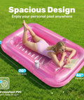 Person relaxing on pink Inflatable Tanning Pool Lounger With Pillow 70 By 46 Inches Personal Water Filled Float in backyard