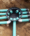Installed Rhino 24 Inch Heavy Duty Catch Basin Kit With 24 Inch Grate, 10 Hole Box connected to green pipes for drainage.