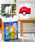 Two Pack Pokemon Gift Bags Bundle 9 Inch Pokeball and 15 Inch Extra Large Pikachu Bags for Kids Teens Gamers displayed on bench