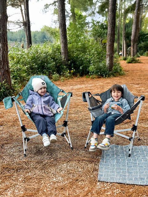 Two children sitting in Kids Hammock Chair Foldable With Stand, Portable Camping Swing Chair With Cup Holder, green and gray.
