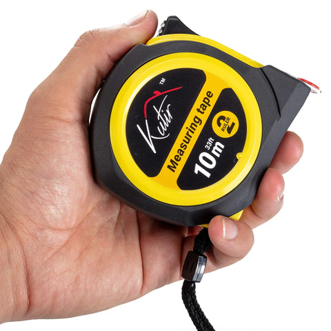 Hand holding 33 Ft Tape Measure With Magnetic Hooks And Fraction Markings Retractable Dual Sided Ruler Shock Absorbent Rubber Case