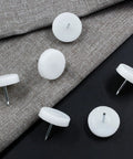 50 Pack Nail On Chair Sliders Round 1 Inch 25mm Plastic Beefy Glides For Heavy Duty Furniture Easy Moving Anti Scratch Floor Protectors For Hardwood Floors White, shown on fabric surface