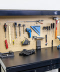 100 Piece Metal Pegboard Hooks And Accessories Set For One Eighth And One Quarter Inch Peg Boards on garage wall with tools