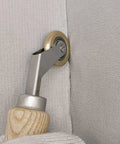 Welding handheld roller with wooden handle and metal neck; brass-toned 40mm wheel rolling on light gray fabric.