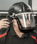 Close-up of man wearing Badass Powered Air Respirator And Hearing Protection Bundle For Woodworking Shops with ear protection.