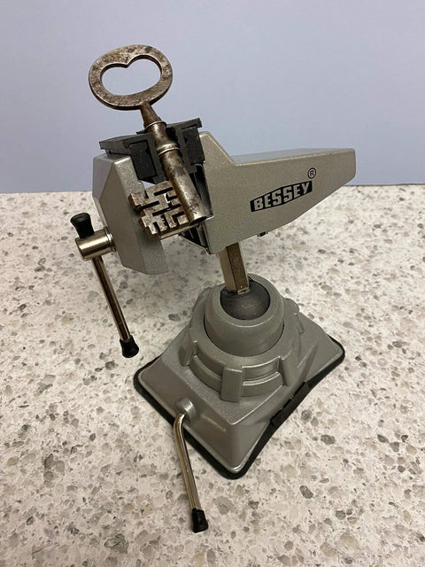 Vacuum Base Vise BV VB with Silver Finish displayed on a counter, ideal for hobbies and electronics, showcasing precise clamping.