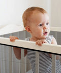 Child near stair banister with Stair Banister Guard Netting Kit For Kids And Pets 2 Pack 18 Ft By 2.6 Ft Mesh Safety Net installed.