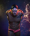 Athlete wearing swim goggles and black swim cap against a starry background