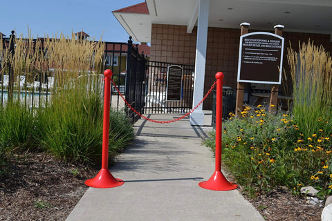 Heavy Duty Red Plastic Barrier Chain For Crowd Control And Straight To Point Line Setup At Outdoor Venues 500 Foot Long Roll With Hella Durable One Inch Links at pool entrance.
