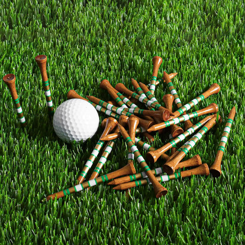 Western Birch Wood Golf Tees 100 Pack With Four Lengths scattered on grass next to a golf ball